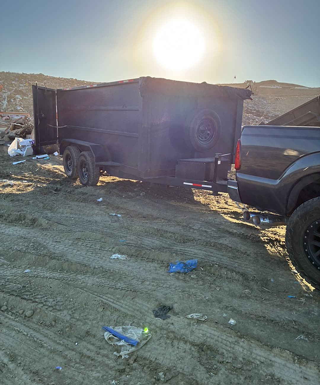 JC's Junk Removal and Hauling dump trailer and truck at the end of a full hauling job near Menifee, California