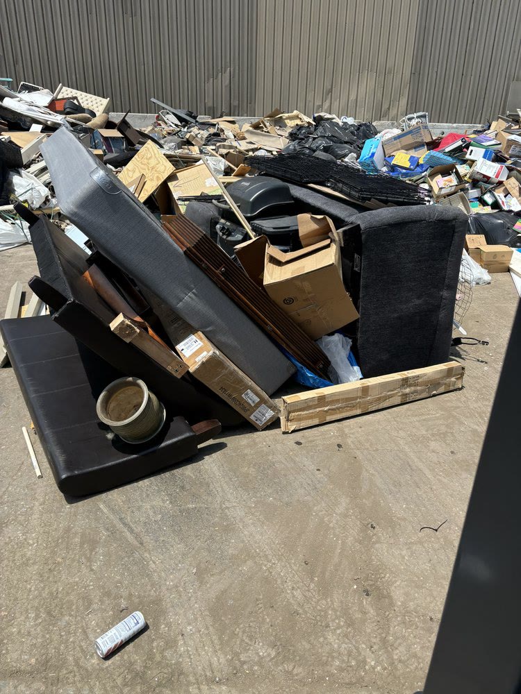 Large pile of mattresses, boxes and household junk cleared from a property
