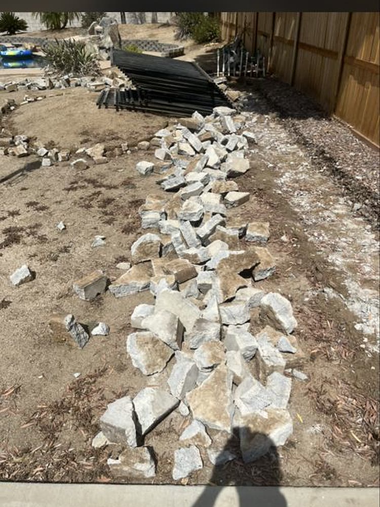 Backyard cleared of broken concrete, stone and old iron fencing